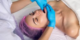 cosmetologist makes a buccal massage